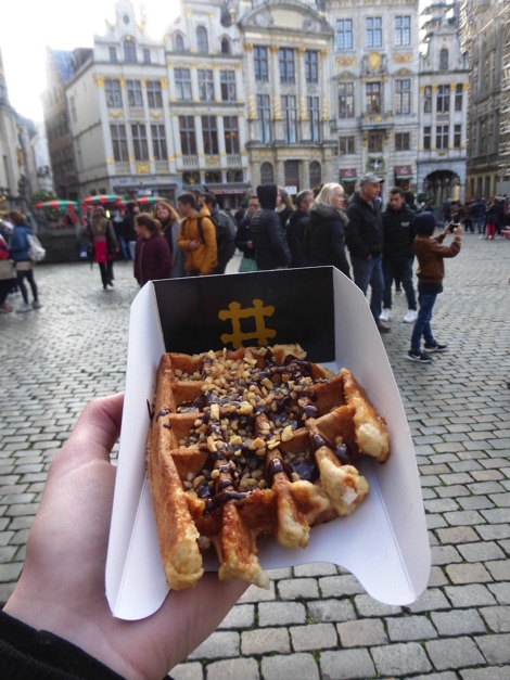 Eating a waffle in Grand Place, Brussels